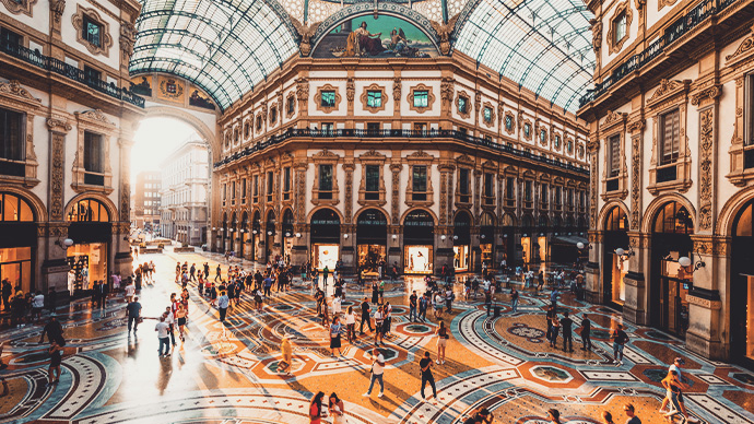 Crowd of people in Galleria Vittorio Emanuele II at sunset, Milan, Italy