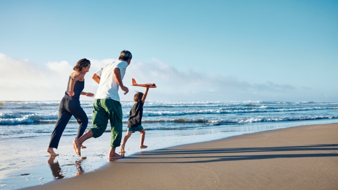 Stock photo of a family running on a beach